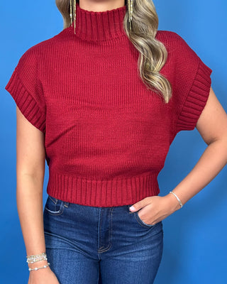 Burgundy mock neck sleeveless knit sweater top with cap sleeves, ribbed trim, and a relaxed fit.