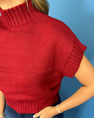 Burgundy mock neck sleeveless knit sweater top with cap sleeves, ribbed trim, and a relaxed fit.