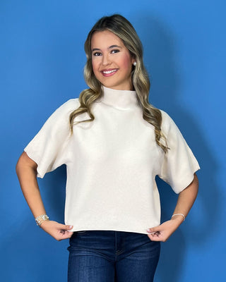Ivory ribbed mock neck sweater top with short dolman sleeves, relaxed fit, and a clean, versatile silhouette.