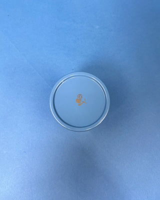 Capri Blue Volcano Artisan Gelato Cup Candle with blue and white striped vessel displayed on blue background. 