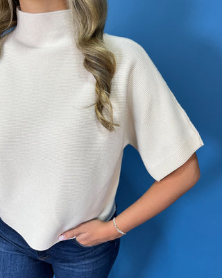 Ivory ribbed mock neck sweater top with short dolman sleeves, relaxed fit, and a clean, versatile silhouette.