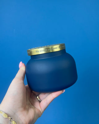 Capri Blue Volcano Artisan Terrazza Candle displayed on solid blue background. 