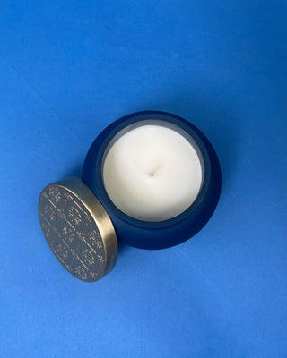 Capri Blue Volcano Artisan Terrazza Candle displayed on solid blue background. 