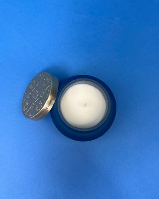Capri Blue Volcano Artisan Terrazza Candle displayed on solid blue background. 