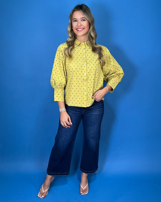 Mustard yellow polka dot button-down top with a pointed collar, statement puff sleeves, and a relaxed feminine fit.