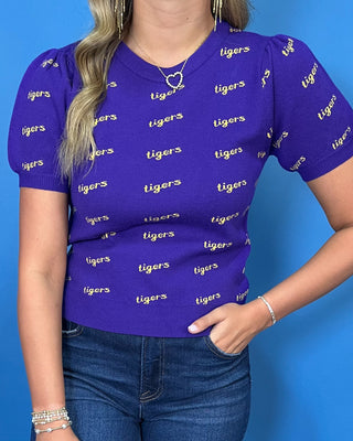 Purple Tigers puff sleeve knit top with an allover gold Tigers print, crew neckline, and ribbed trim.