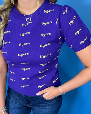 Purple Tigers puff sleeve knit top with an allover gold Tigers print, crew neckline, and ribbed trim.
