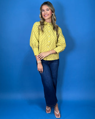 Mustard yellow polka dot button-down top with a pointed collar, statement puff sleeves, and a relaxed feminine fit.