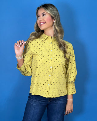 Mustard yellow polka dot button-down top with a pointed collar, statement puff sleeves, and a relaxed feminine fit.