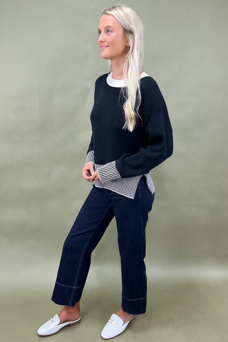 Black knit sweater with striped trim styled with dark wide leg cropped jeans and white loafers, casual fall outfit