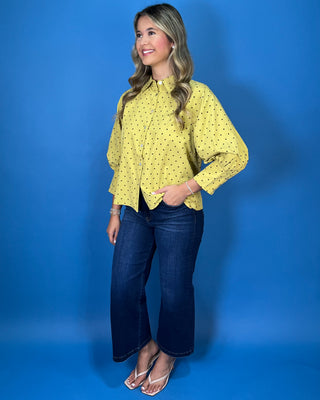 Mustard yellow polka dot button-down top with a pointed collar, statement puff sleeves, and a relaxed feminine fit.