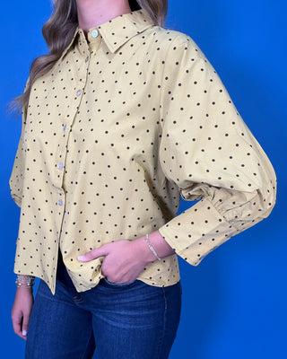 Mustard yellow polka dot button-down top with a pointed collar, statement puff sleeves, and a relaxed feminine fit.