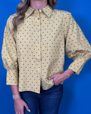 Mustard yellow polka dot button-down top with a pointed collar, statement puff sleeves, and a relaxed feminine fit.
