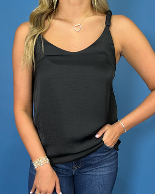 Black sleeveless satin camisole top with a V-neckline, braided shoulder straps, and relaxed silhouette.