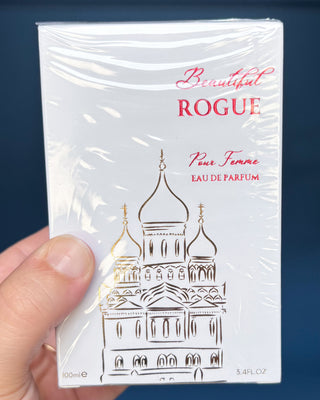 Perfume bottle and packaging of 'Beautiful Rogue' on a blue background