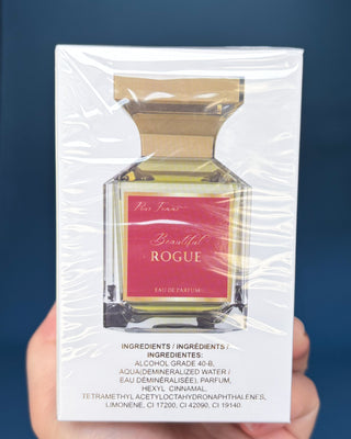 Perfume bottle and packaging of 'Beautiful Rogue' on a blue background