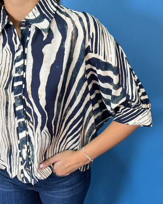 Navy and ivory abstract zebra print button-down top with a collared neckline, relaxed fit, and three-quarter sleeves.