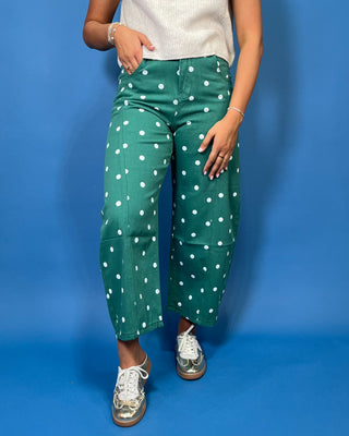 Green high-rise wide leg cropped jeans with an allover white polka dot print, front pockets, and seam detailing.