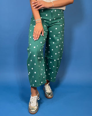 Green high-rise wide leg cropped jeans with an allover white polka dot print, front pockets, and seam detailing.