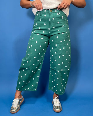 Green high-rise wide leg cropped jeans with an allover white polka dot print, front pockets, and seam detailing.