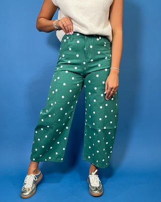 Green high-rise wide leg cropped jeans with an allover white polka dot print, front pockets, and seam detailing.
