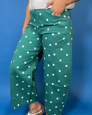 Green high-rise wide leg cropped jeans with an allover white polka dot print, front pockets, and seam detailing.