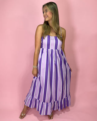 Navy blue halter top with a bow detail on a pink background