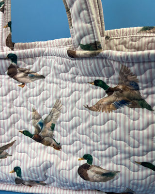 Quilted Ida Mae Home tote bag with watercolor mallard duck print, striped fabric, spacious interior, and padded shoulder straps.