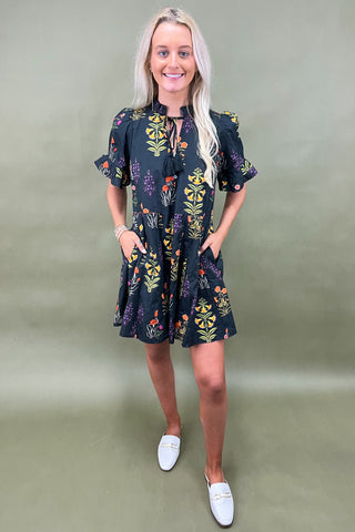 Woman wearing a floral dress with a plain background