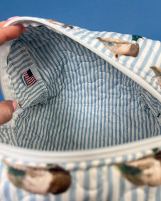 Quilted Ida Mae Home makeup bag with watercolor mallard duck print, blue striped fabric, zip closure, and spacious travel-friendly design.