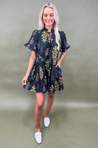 Woman wearing a floral dress with a plain background