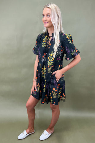 Woman wearing a floral dress against a green background