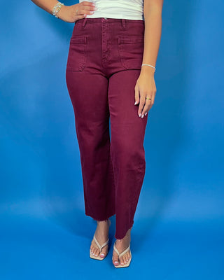 Burgundy high-rise cropped straight leg jeans with front patch pockets and a trendy raw hem.
