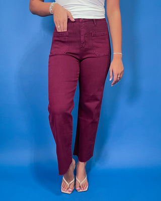 Burgundy high-rise cropped straight leg jeans with front patch pockets and a trendy raw hem.