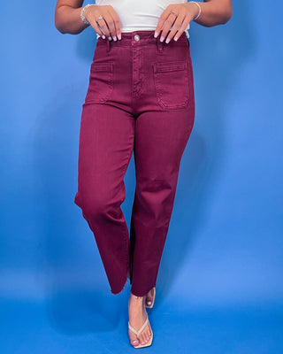 Burgundy high-rise cropped straight leg jeans with front patch pockets and a trendy raw hem.