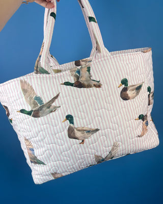 Ida Mae Home quilted handbag with pink and blue striped fabric, mallard duck print, padded shoulder straps, and spacious open interior.