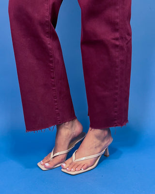 Burgundy high-rise cropped straight leg jeans with front patch pockets and a trendy raw hem.
