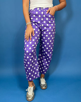 Purple high-rise polka dot pants with bold white dots, a flattering straight-leg silhouette, and cropped ankle length.