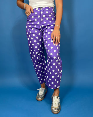 Purple high-rise polka dot pants with bold white dots, a flattering straight-leg silhouette, and cropped ankle length.