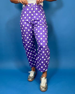 Purple high-rise polka dot pants with bold white dots, a flattering straight-leg silhouette, and cropped ankle length.