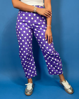 Purple high-rise polka dot pants with bold white dots, a flattering straight-leg silhouette, and cropped ankle length.