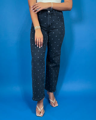 Black high-rise polka dot jeans with subtle gray dots, a flattering slim straight-leg fit, and ankle-length silhouette.