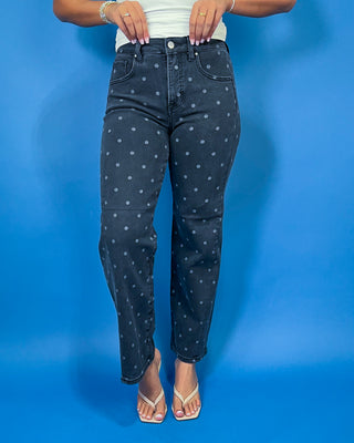 Black high-rise polka dot jeans with subtle gray dots, a flattering slim straight-leg fit, and ankle-length silhouette.