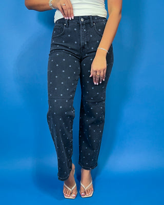 Black high-rise polka dot jeans with subtle gray dots, a flattering slim straight-leg fit, and ankle-length silhouette.