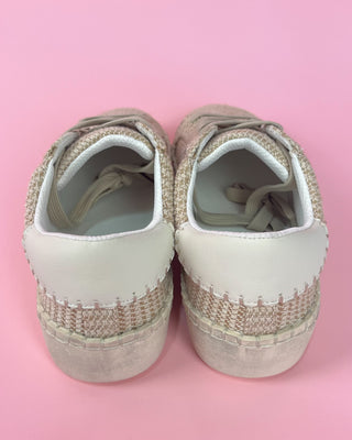 Beige woven sneaker with white sole against a pink background