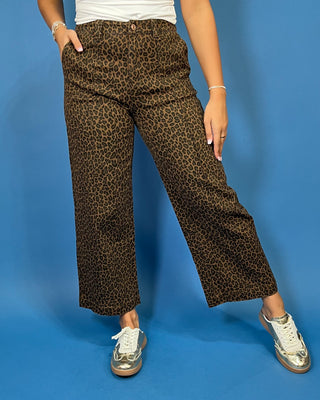 Brown leopard print high-rise pants with a flattering wide-leg silhouette, cropped length, and convenient side pockets.