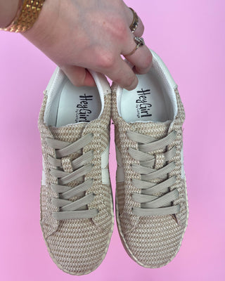 Beige woven sneaker with white sole against a pink background