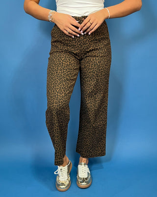 Brown leopard print high-rise pants with a flattering wide-leg silhouette, cropped length, and convenient side pockets.