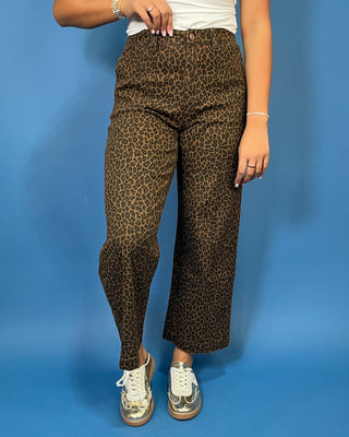 Brown leopard print high-rise pants with a flattering wide-leg silhouette, cropped length, and convenient side pockets.