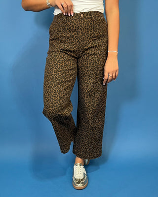Brown leopard print high-rise pants with a flattering wide-leg silhouette, cropped length, and convenient side pockets.